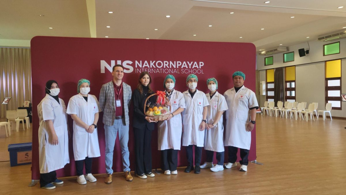 Organizer Lola G12 and Principal Ben present a gift basket to the Thai Red Cross nurses
